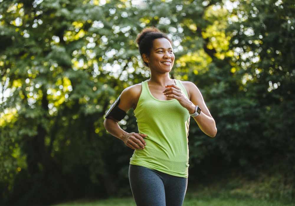 Resident woman going for a run in the park nearby Wasatch Club Apartments in Midvale, Utah