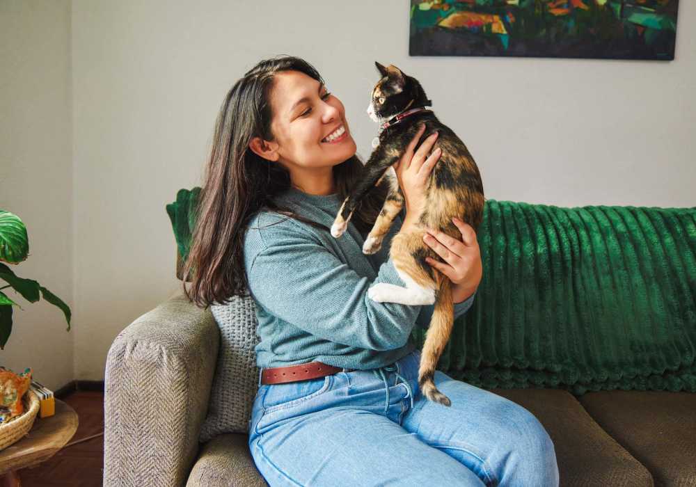 Woman playing with his cat at Mission Pointe Club Apartments in Euless, Texas