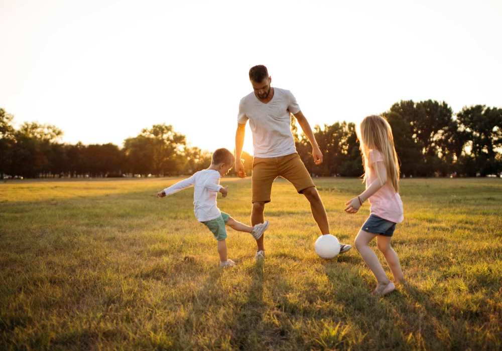 Resident playing with his kids in a playground at Tabby Villa Apartments in Savannah, Georgia