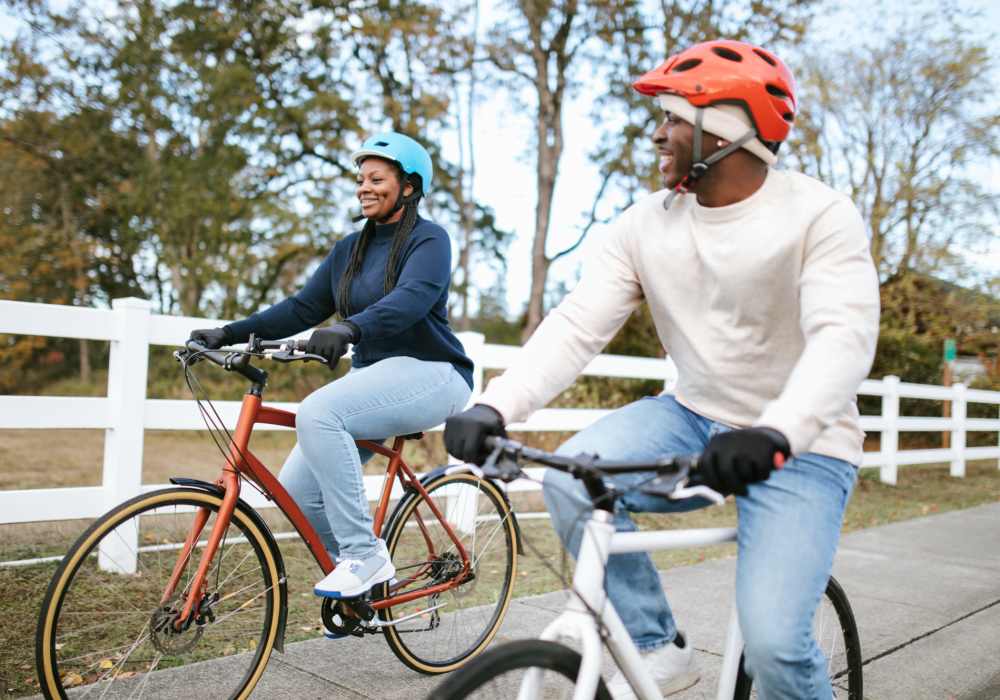 Resident couple riding a bike near Crystal Commons Townhomes in Gates, New York