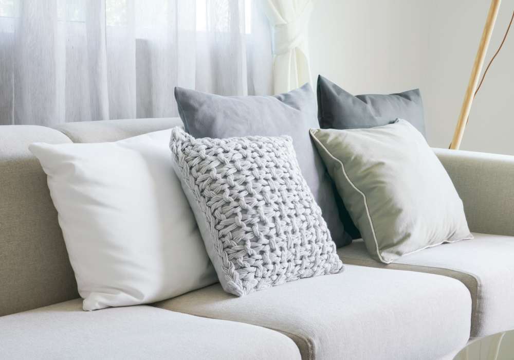 Living room with an elegant neutral color palette at Heritage Park Apartments & Townhomes in Webster, New York