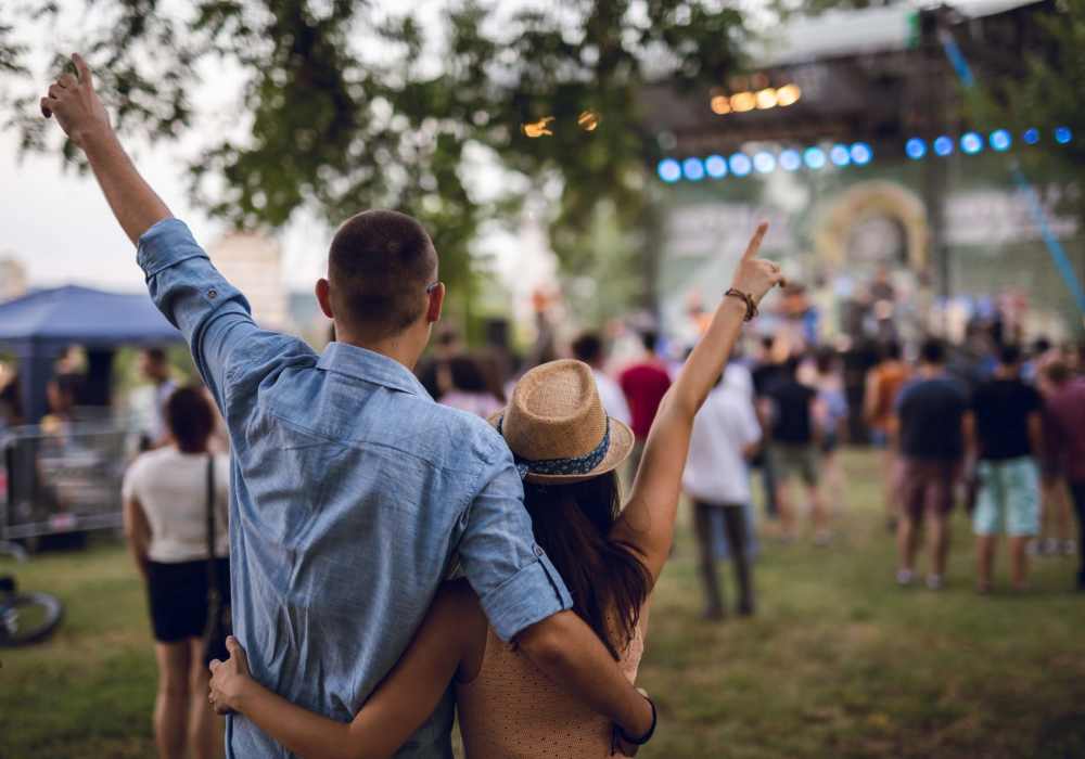 Resident couple standing together at an outdoor event near Charleston at Fannin Station in Houston, Texas