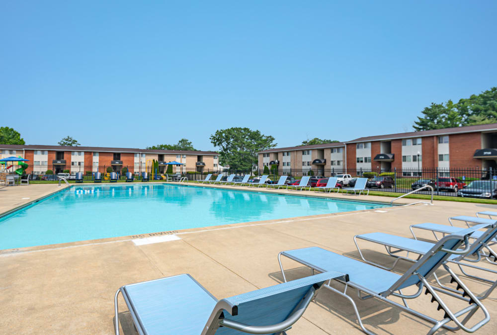 Swimming pool surrounded by sunny lounge chairs at Seneca Bay Apartment Homes in Middle River, Maryland