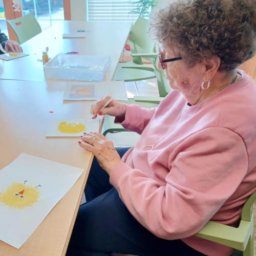 Resident filling out a questionnaire at The Oxford Grand Assisted Living & Memory Care in Wichita, Kansas