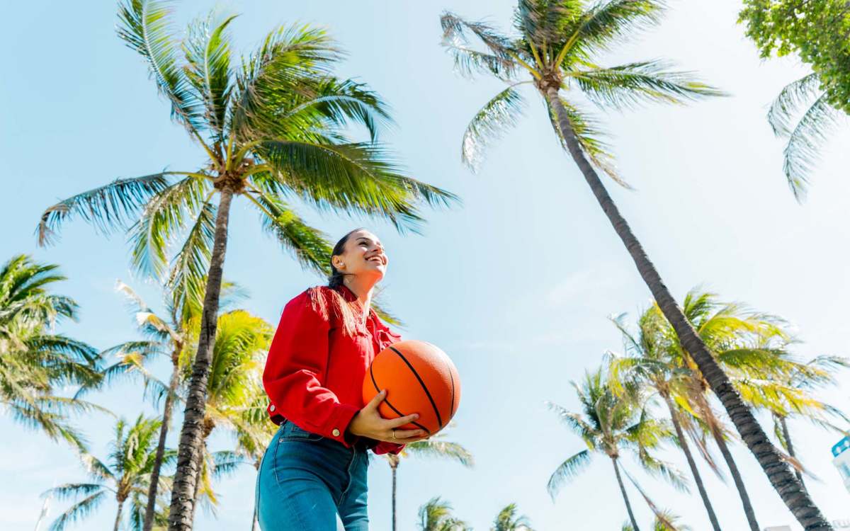 Woman carrying a basketball near Valencia Park in Orlando, Florida