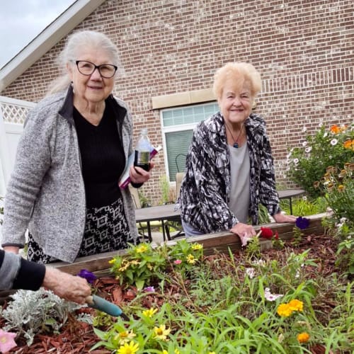 Residents outside watering plants at Oxford Glen Memory Care at Owasso in Owasso, Oklahoma