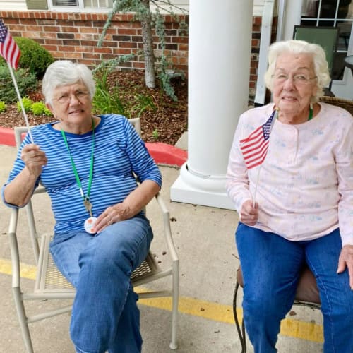 Two residents with flags at Canoe Brook Assisted Living in Broken Arrow, Oklahoma