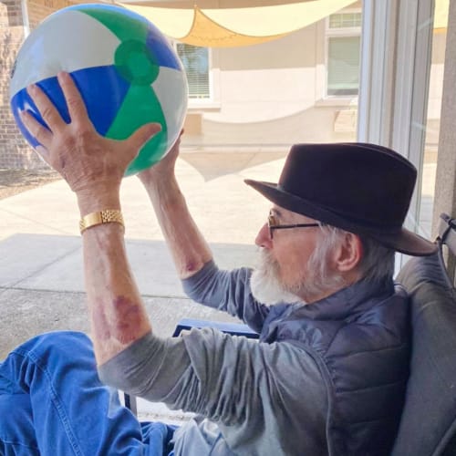 Resident playing with a ball at Oxford Glen Memory Care at Sachse in Sachse, Texas