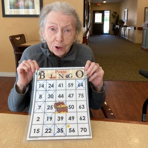 A resident crafting at Oxford Glen Memory Care at Carrollton in Carrollton, Texas