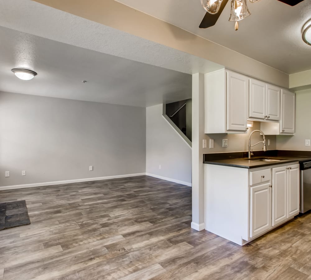 Kitchen with wood-style flooring in a townhouse at Slate Ridge at Fisher's Landing Apartment Homes in Vancouver, Washington