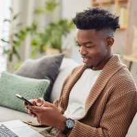 Resident using his mobile at The Warwick at Foundry Creek in Richmond, Virginia