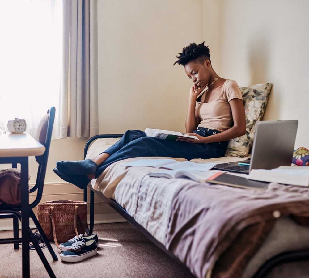 Student resident studying book at Polly O'Meara Doyle Hall in Santa Rosa, California