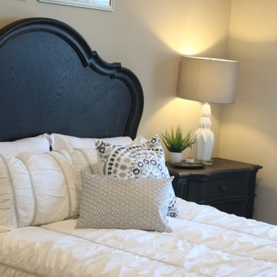 Modern bedroom with night stand and soft lighting at The Sanctuary at Brooklyn Center in Brooklyn Center, Minnesota