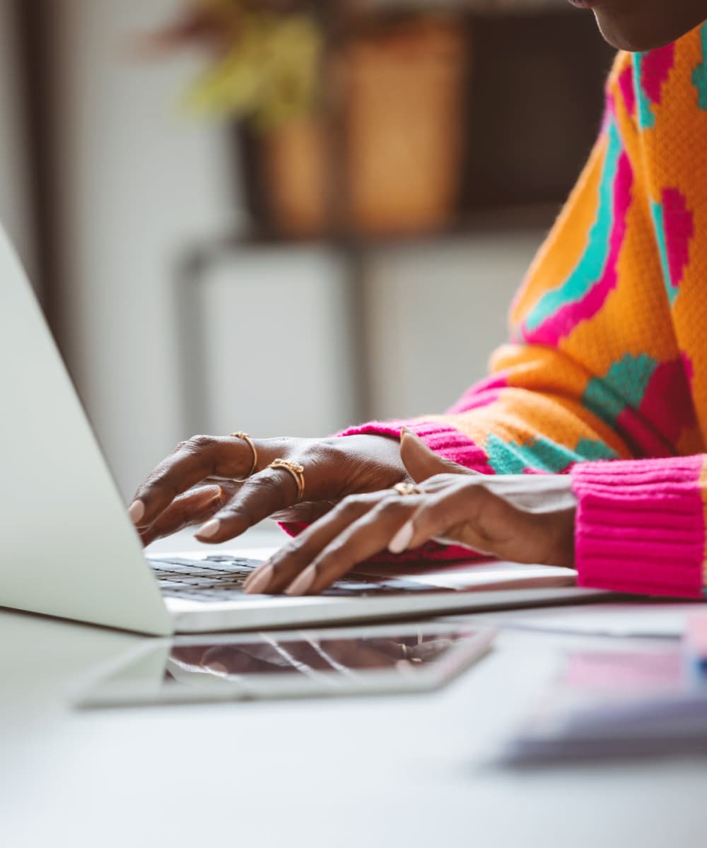 Woman working on her laptop at ARTISAN Management Group in Des Moines, Iowa