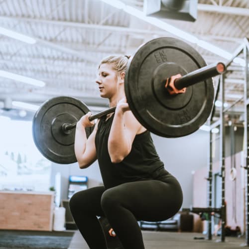 A woman lifting weights at Shelton Circle in Virginia Beach, Virginia