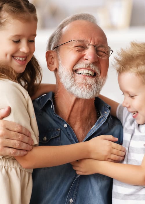 Resident holding their two grandchildren at Burton Health Care Center in Burton, Ohio