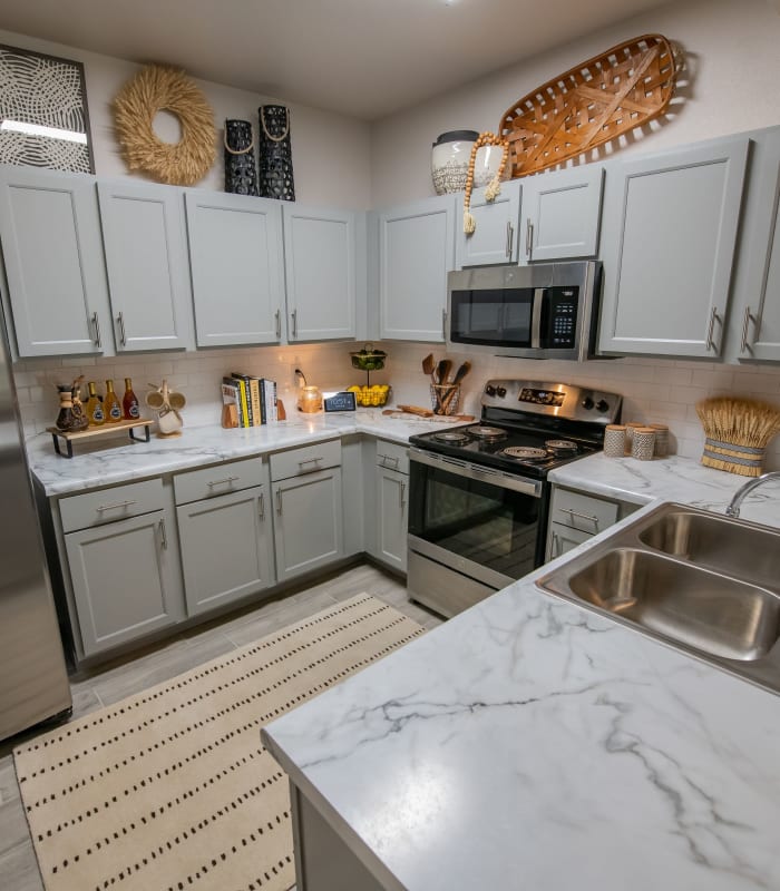 Kitchen with granite countertops at Redbud Ranch Apartments in Broken Arrow, Oklahoma