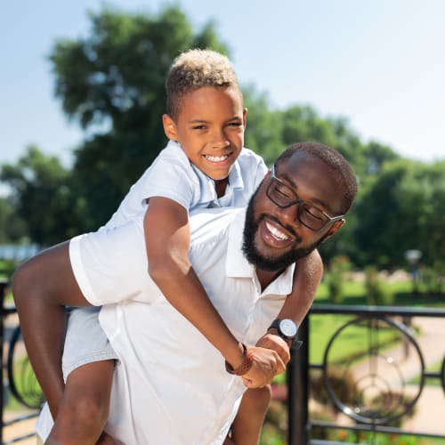 A father holding his son at Castle Acres in Norfolk, Virginia