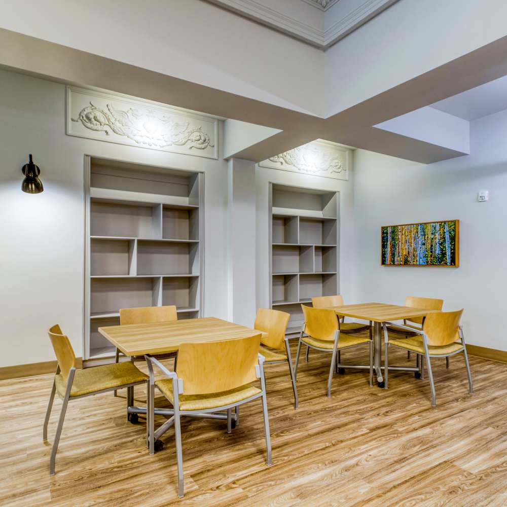Communal sitting area with bookshelves at Argonaut/El Tovar Apts in Denver, Colorado