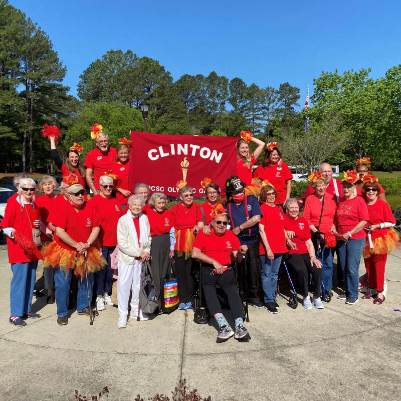 Residents with a city of clinton flag at The Clinton Presbyterian Community in Clinton, South Carolina