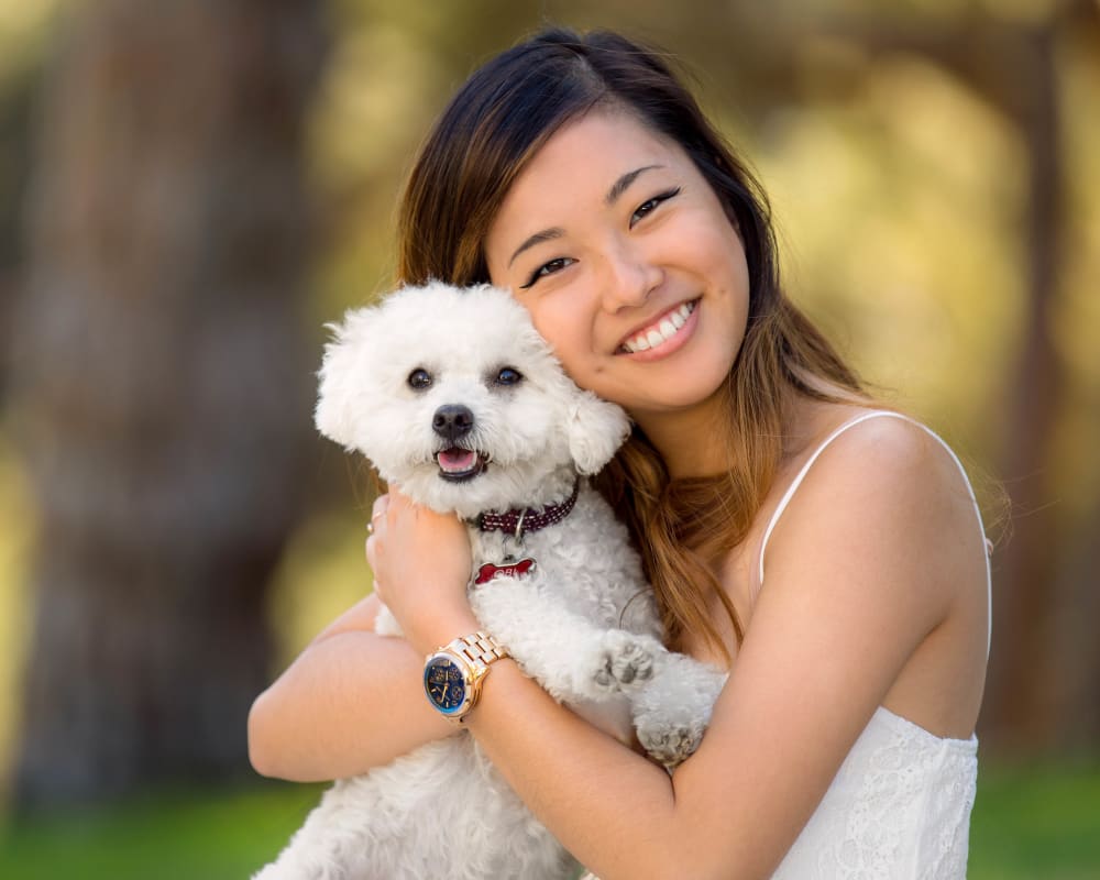 Resident and her dog posing for a photo opp in a park near The Loop at 2800 in Sarasota, Florida