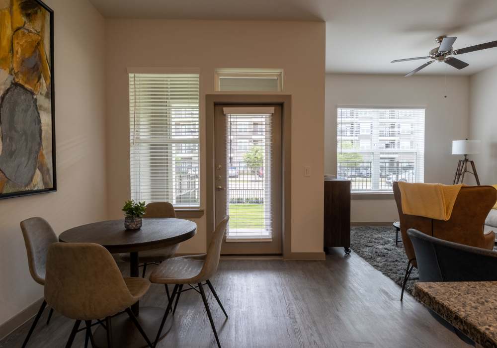 Cozy apartment dining nook featuring a round table with upholstered chairs at Charleston at Fannin Station in Houston, Texas