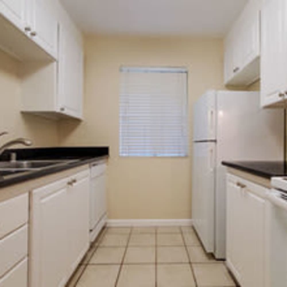 Interior view of Kitchen with white cabinets and black countertops at our Sonoma Mission community at Mission Rock at Sonoma in Sonoma, California