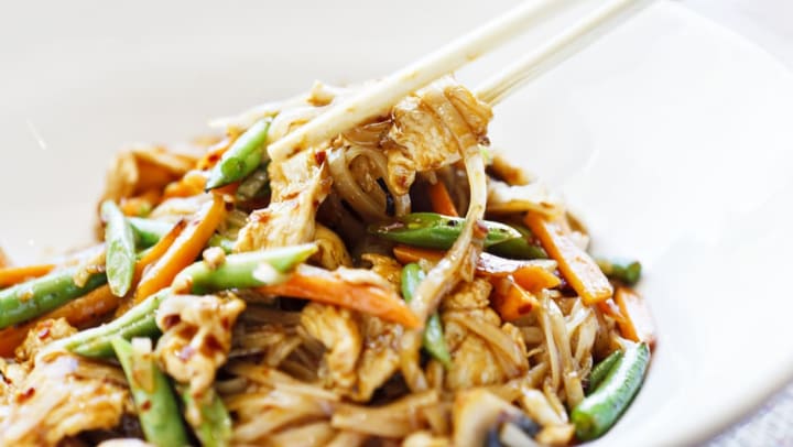 chopsticks and bowl of Thai stir fry noodles with vegetables | drunken noodles in Gilbert