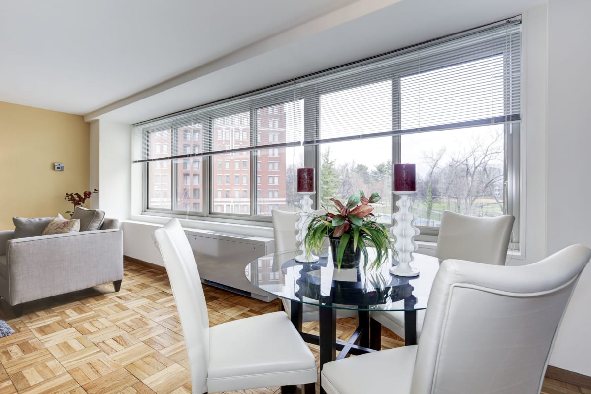 Hardwood floors in the living and dining area with large windows for a nice view at The Brandywine Apartments in Washington, District of Columbia