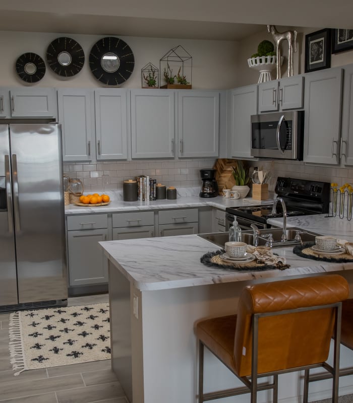 Kitchen with granite countertops at Bend at New Road Apartments in Waco, Texas