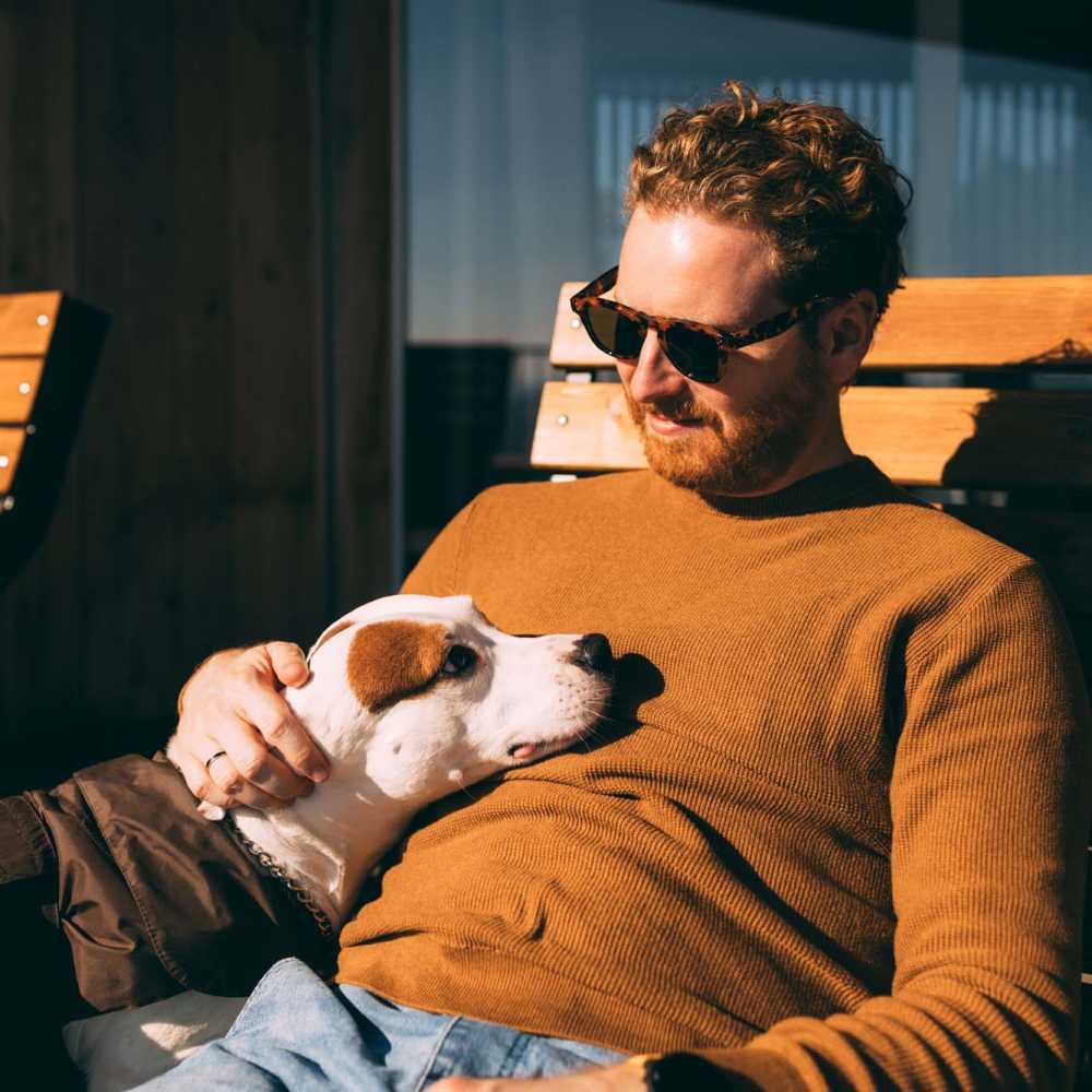 Resident with his pet dog at Breeze Apartments in Gulf Breeze, Florida