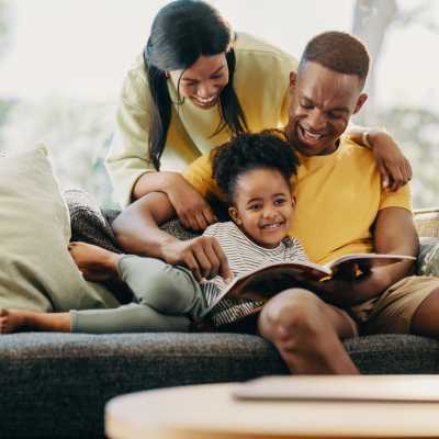 Happy family sitting on couch at Fifteen in Miami, Florida