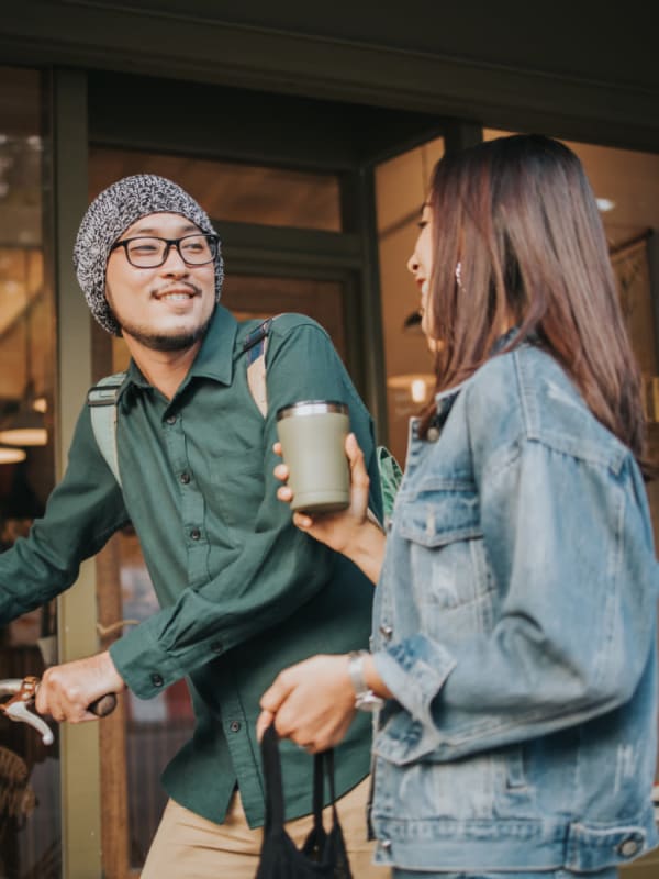 Residents chatting outside of a coffee shop in Katy, Texas near Bellrock Market Station