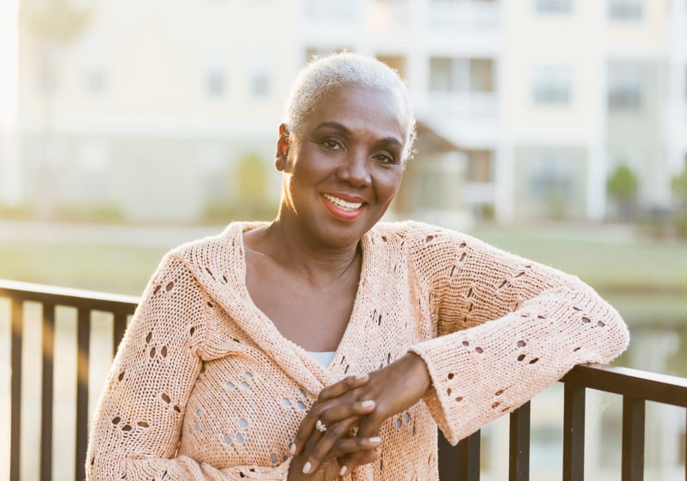 Woman on the balcony at Fairbrooke Senior Apartments in Aberdeen, Maryland