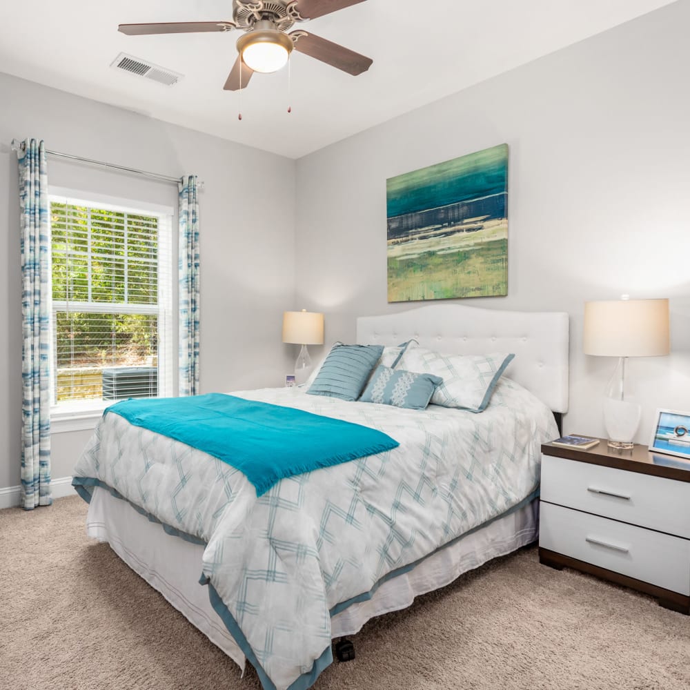 Plush carpeting in a furnished apartment bedroom with a door to the balcony at Retreat at the Park in Burlington, North Carolina