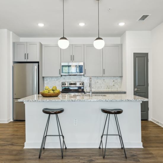 Modern kitchen with island seating at The Southerly at Orange City in Orange City, Florida