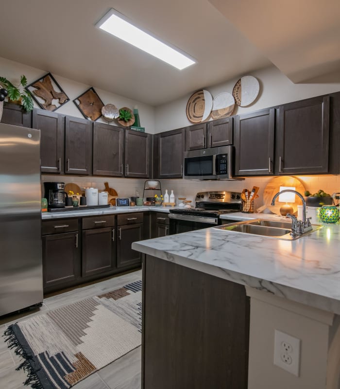 Kitchen with granite countertops at Redbud Ranch Apartments in Broken Arrow, Oklahoma