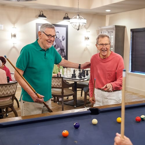 Residents playing pool in the game room at The Crossings at Eastchase in Montgomery, Alabama
