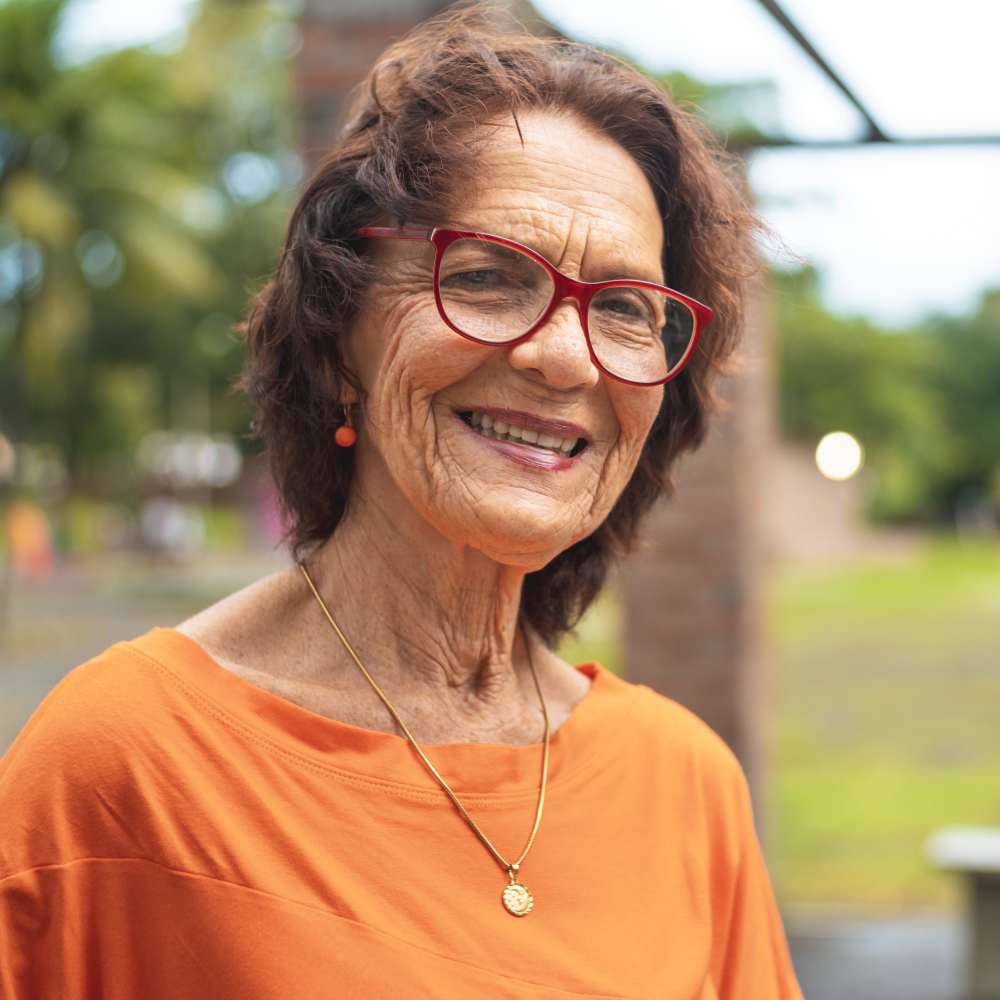 Resident senior woman smiling outdoors at Clearwater at The Arboretum in Austin, Texas