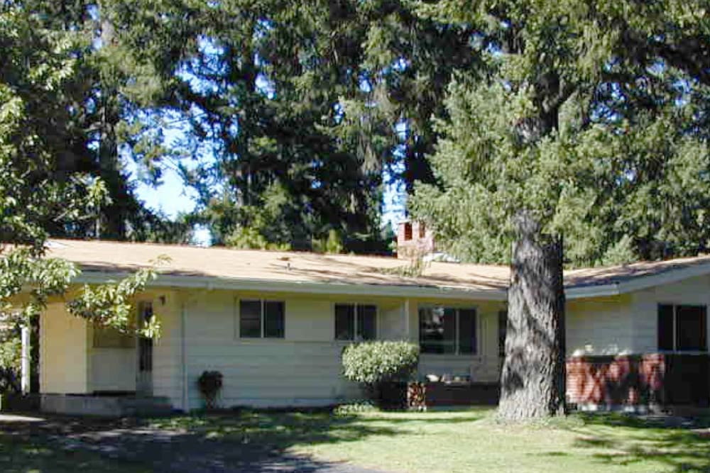 A home shaded by trees at Broadmoor in Joint Base Lewis-McChord, Washington