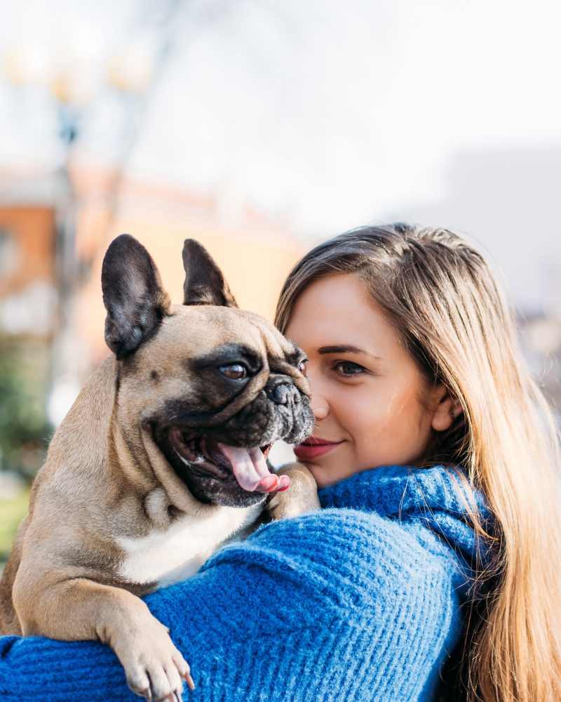 Resident holding her pup on a walk near The District in Asheville, North Carolina