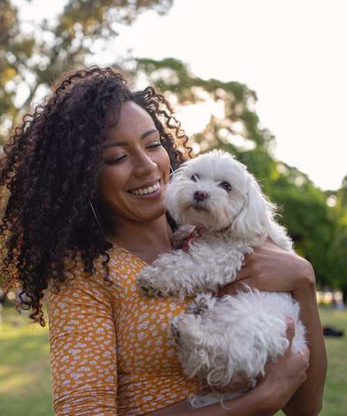 Resident with her pet in park near at Rivercrest in Waco, Texas