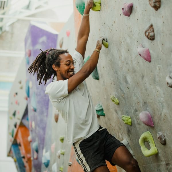 Resident climbing at an indoor rock gym near Duet in Nashville, Tennessee