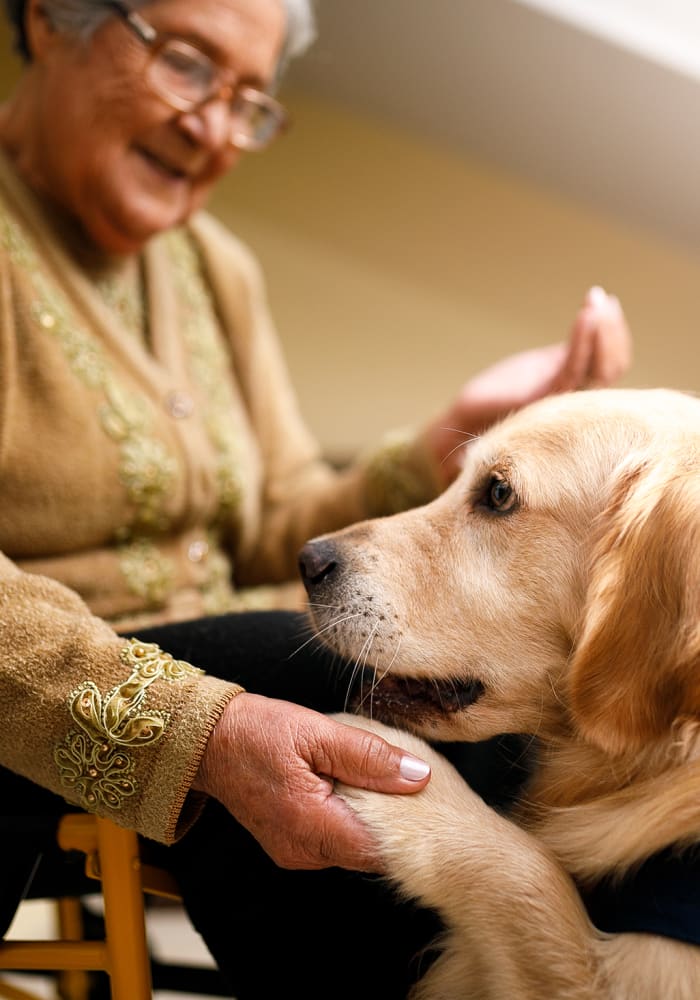 A resident with her dog at Arbor Rose Senior Care in Mesa, Arizona