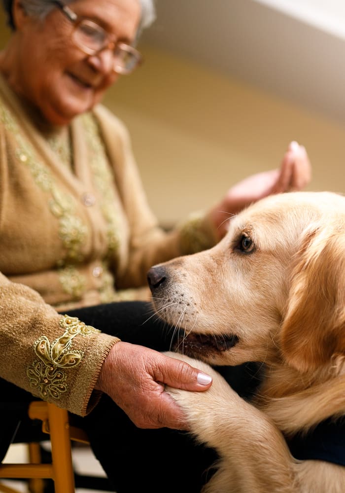 A resident with her dog at Sierra Ridge Memory Care in Auburn, California