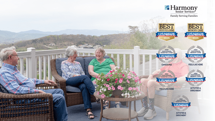 Seniors sitting outside overlooking the mountains. U.S. News & World Report emblems to show Harmony was named among Best Senior Living communities  