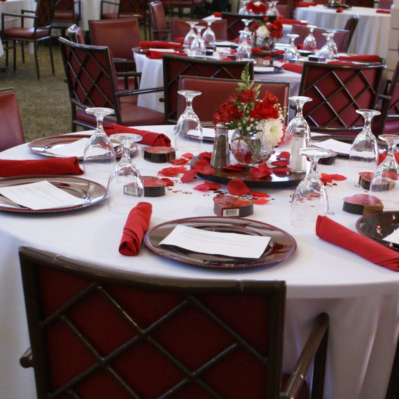 Beautifully set dining room in red at The Foothills Retirement Community in Easley, South Carolina