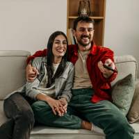 Resident couple watching TV at Stonebridge Apartment Homes in Lufkin, Texas