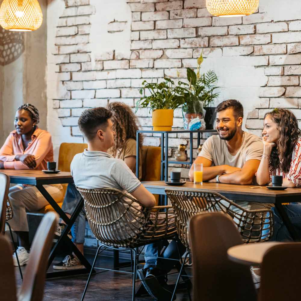 People sitting and talking at Avia Lofts at Maple Road in Amherst, New York