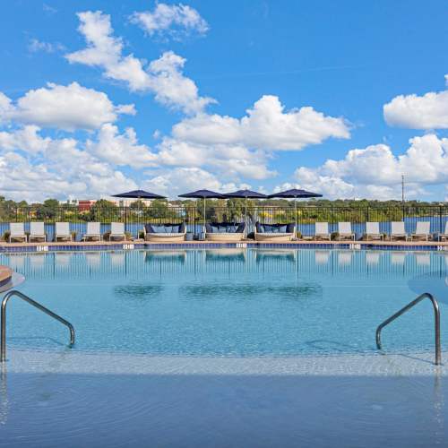 Poolside view with loungers and shaded seating The Carlton At Lake Dexter in Winter Haven, Florida
